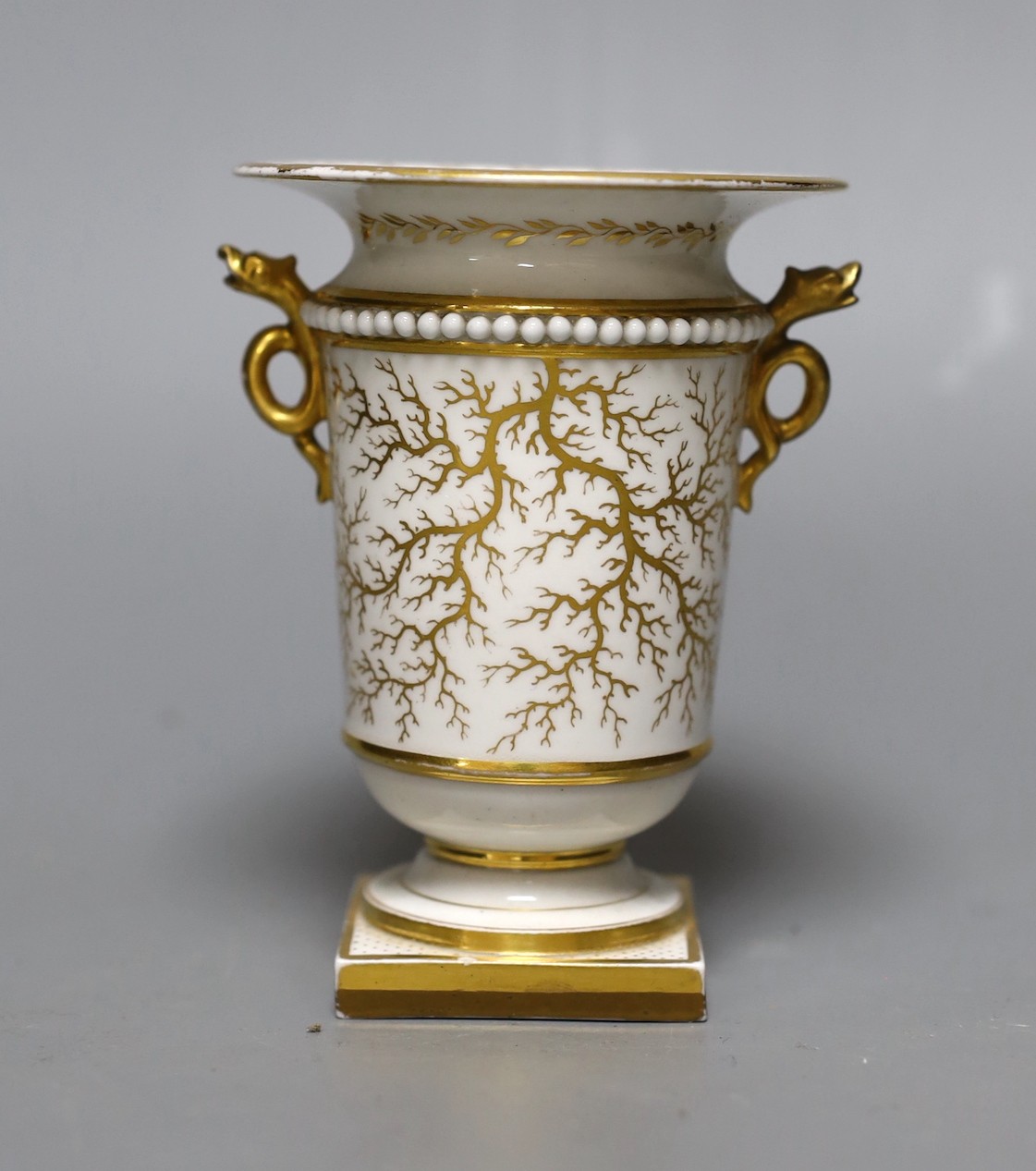 An early 19th c. Flight Barr and Barr Worcester fine spill vase with serpent head handles painted with a landscape of a small sailing boat at dock, titled Windermere, Westmorland script mark, 11 cms high